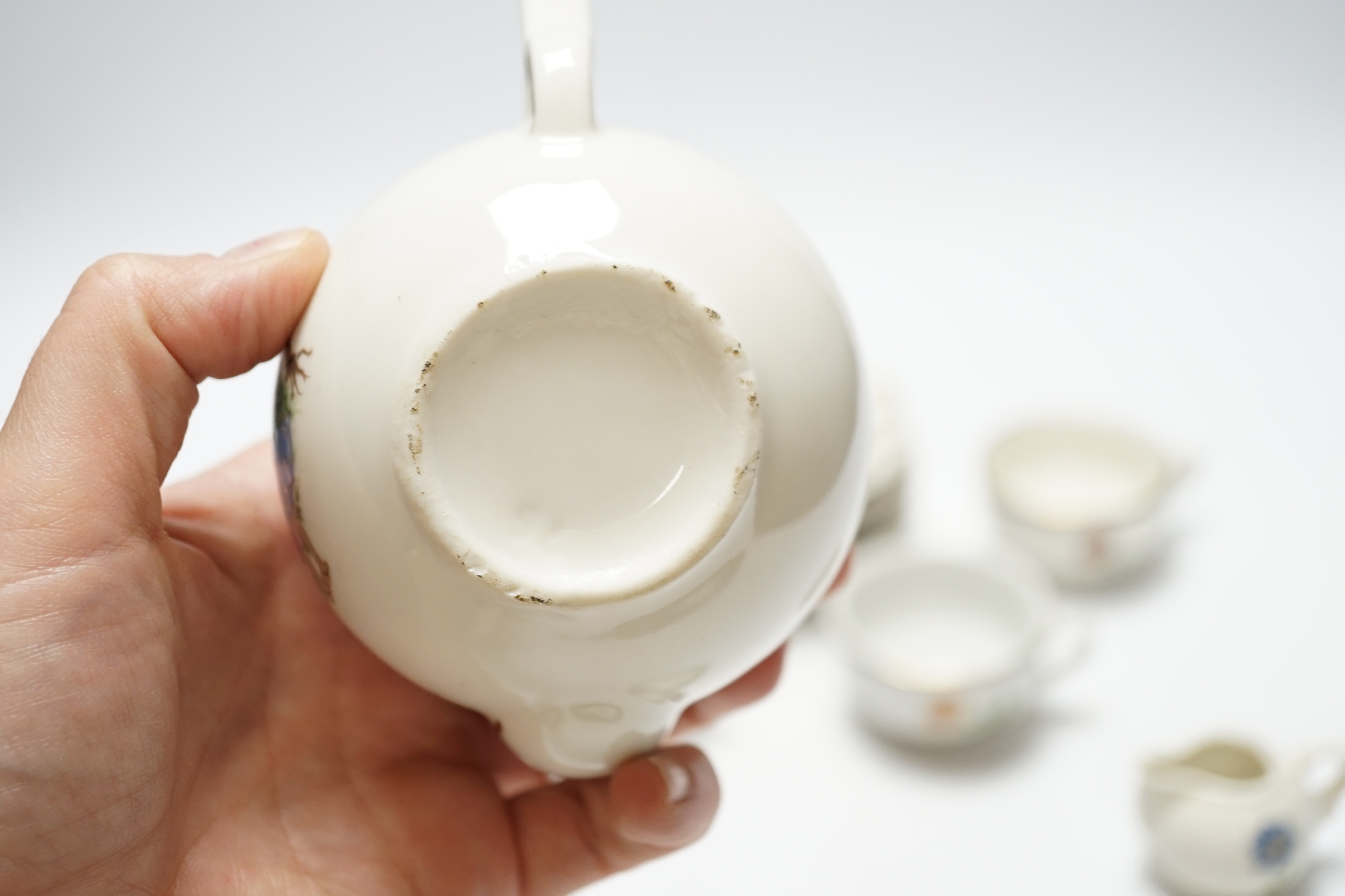 A child’s tea set comprising a teapot, five cups and saucers and a milk jug, teapot 8.5cm